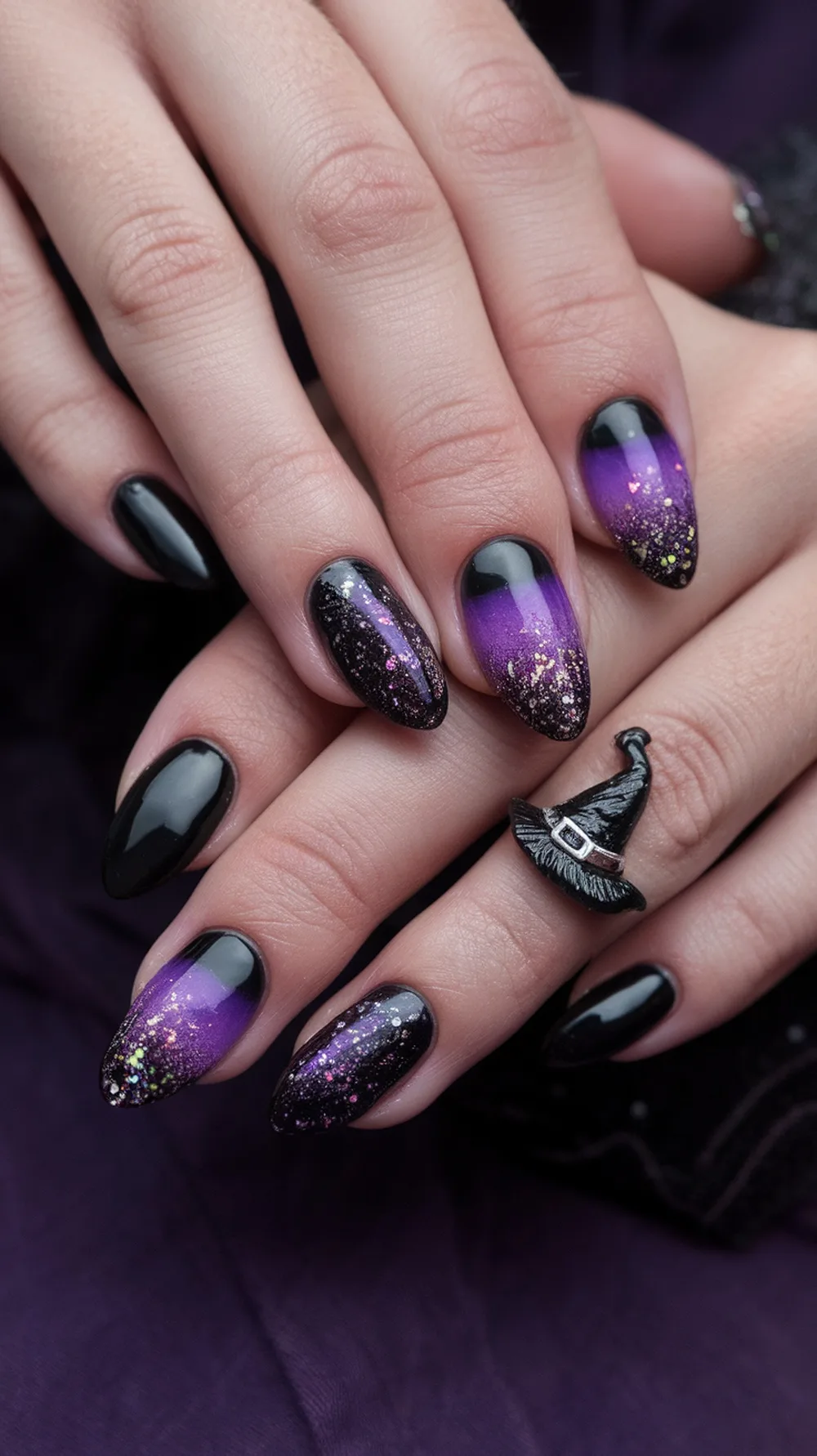 Witchy black and purple ombre nail design with glitter