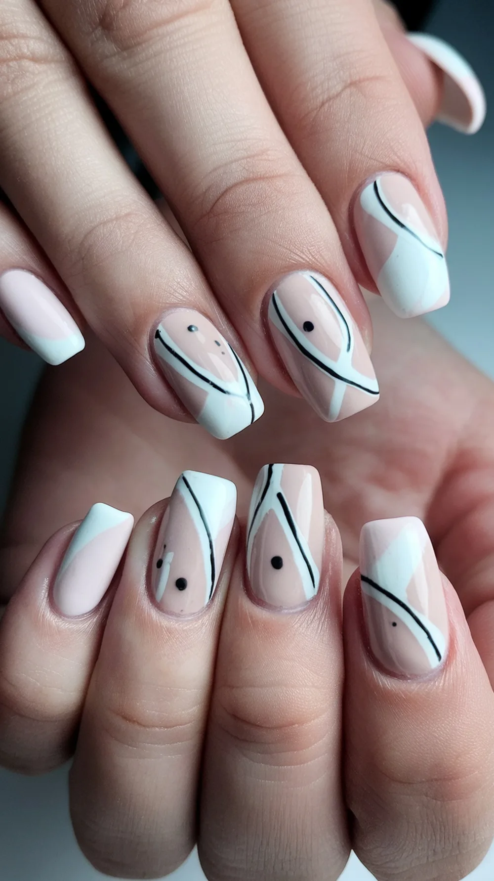 Minimalist nail art featuring pastel colors and black accents.